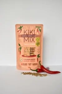 “Kiki Mix Chilli Cumin Seed Crackers 300g pack with red chillies and cumin seeds displayed in front, gluten-free gourmet crackers made with all-natural ingredients